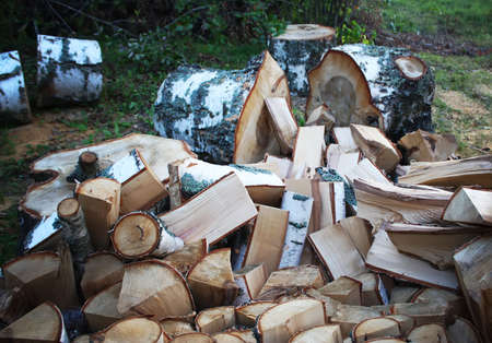 Firewood background - chopped firewood on a stackの写真素材