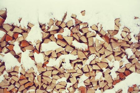 Firewood background - chopped firewood on a stackの写真素材
