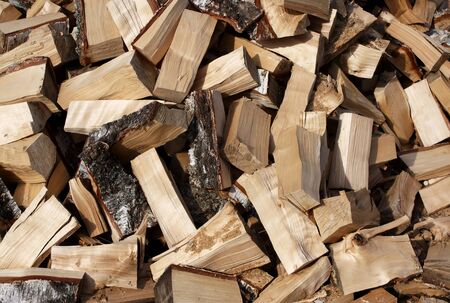 Firewood background - chopped firewood on a stack