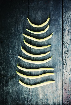 Green beans on wooden surface. Close up top view.の写真素材