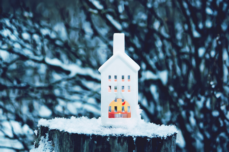 Christmas lantern with burning candle on winter nature background.の写真素材