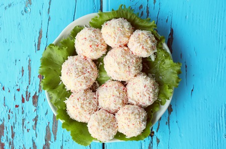 Crab-cheese balls with salad on blue wooden table background.の写真素材