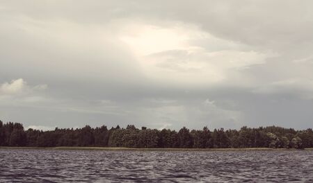 Lake in Latvia. Water surface with small waves in a windy day.