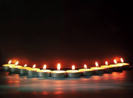 Burning candles on dark background.の写真素材