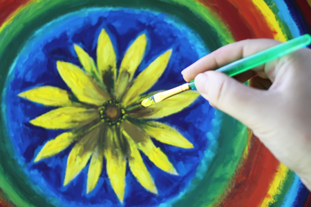 Process of painting by oil paints on canvas. A hand with brush.の写真素材