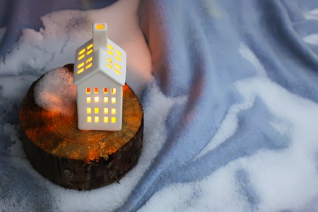 Decorative house lantern with burning candle in autumn park at evening.の写真素材