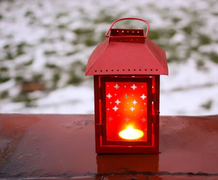 Decorative lantern with burning candle in autumn park at evening.の写真素材