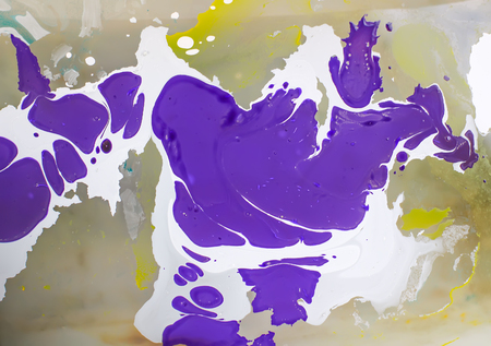 Process of creating ebru painting by colorful paints, paper and wooden stick. Bright abstract pattern in water.の写真素材