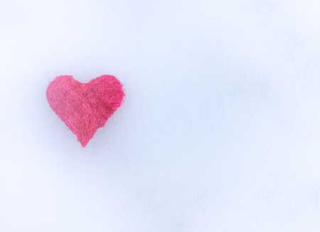 Pink heart on the snow.の写真素材