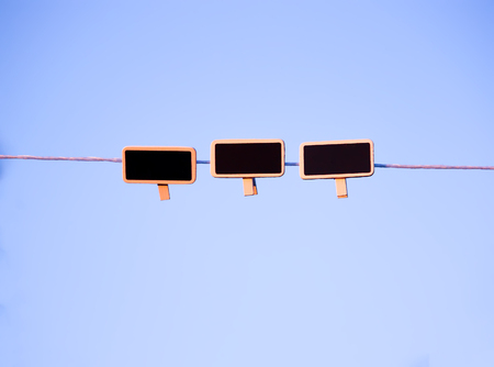 Small black framed chalkboards hanging outdoorsの写真素材