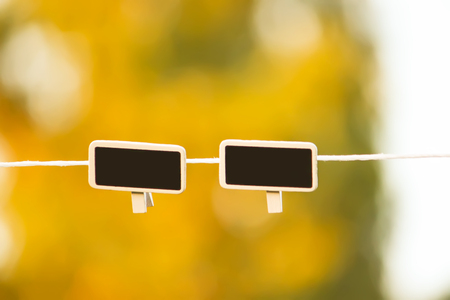 Small black framed chalkboards hanging outdoorsの写真素材