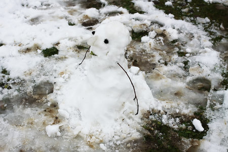 Cute snowman on rural yard.の写真素材