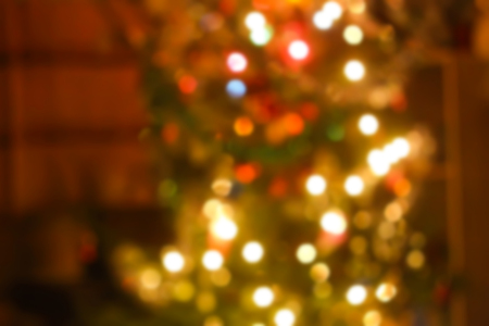 Decorated fir tree. Golden blur bokeh light background.の写真素材