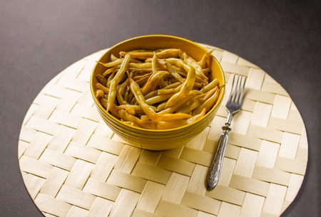 Fried long french beans in yellow ceramics cup.の写真素材