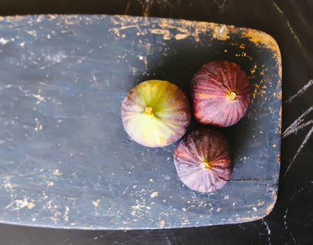 Fresh violet figs fruits on dark wooden surfaceの写真素材