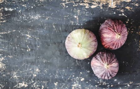Fresh violet figs fruits on dark wooden surfaceの写真素材