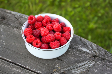 Fresh sweet ripe raspberries on nature background.