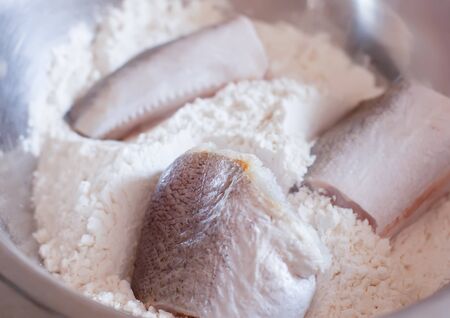Fresh raw fish in a meal prepared for cookingの写真素材