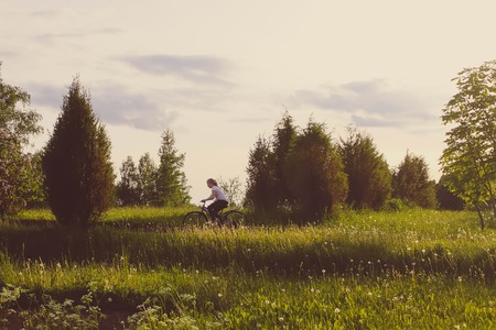 Cute little girl running on a meadow at summer in the countryside.の写真素材
