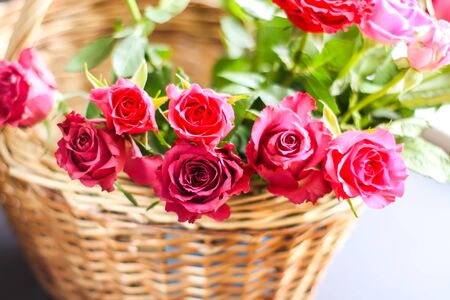 Beautiful pink and red roses in a basket.の写真素材