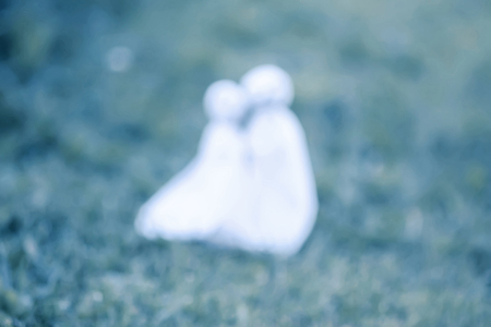 Decoration for Halloween. Unfocused image. Blurred background. Two ghost figures. Handmade decor for party.の写真素材