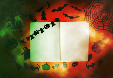 Decorations for Halloween party. Handmade paper decor. Festive greeting card, poster, banner design. Spider web, pumpkin, bat, cats, ghosts and spiders with opened pad on bright smoky background.の写真素材