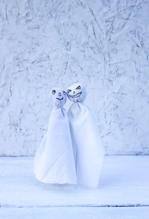 Decoration for Halloween. Two ghost figures on light background. Handmade decor for party.の写真素材
