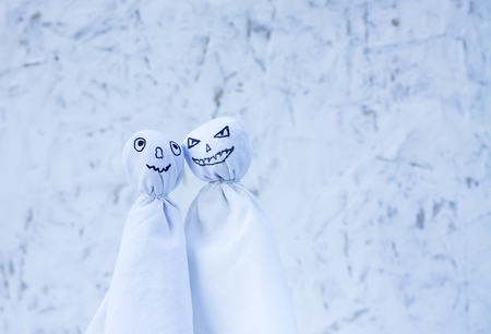 Decoration for Halloween. Two ghost figures on light background. Handmade decor for party.の写真素材