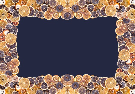 Symmetrical frame of dry slices of orange and grapefruit. Fruit chips background. Decorative banner.