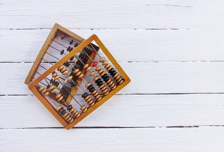 Vintage wooden abacus on white board surface.の写真素材