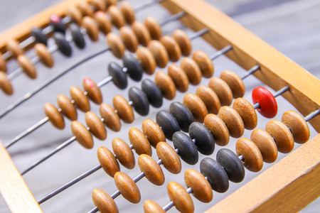 Vintage wooden abacus on old board surface.の写真素材