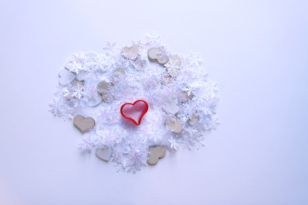 Artificial snowflakes and red decorative heart on white softの写真素材