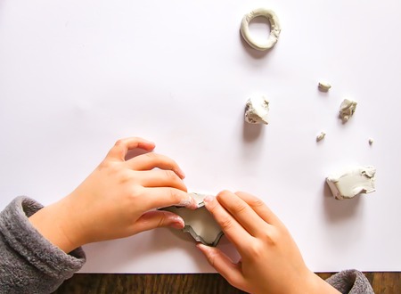 Child make figures from modeling clay. Creative activities in the process. Christmas and New Year handmade decor.の写真素材