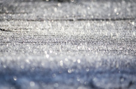 Rime cover on the ground. Hoarfrost on wooden surface outdoors.の写真素材