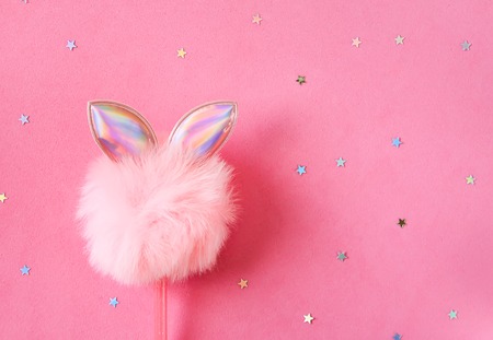 Decorative Christmas and New Year background with fluffy pink pompon and colorful tinsel. Festive template. Greeting card with copy space.の写真素材