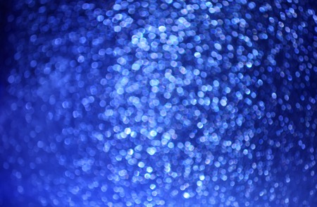 Wrapping paper background with colorful glitter texture. Christmas, New Year festive decoration. Sparkling bright surface.の写真素材