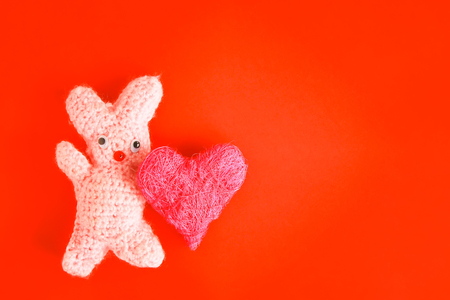 Valentines Day festive card with crocheted handmade toy bunny and decorative heart.の写真素材