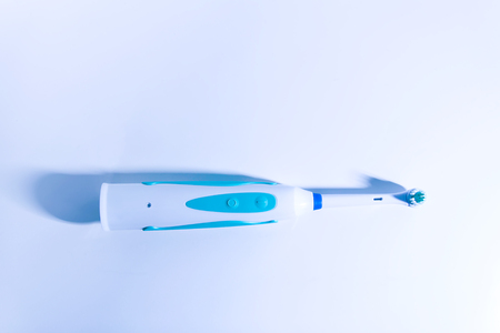 Modern electric toothbrush for healthy teeth on light soft background.の写真素材