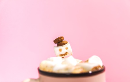 Ceramic mug with hot fresh cocoa drink and melted handmade funny marshmallow snowman.の写真素材