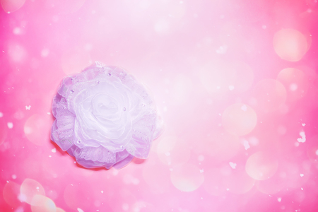White ribbon bow on soft pink background. Festive decorative element.の写真素材