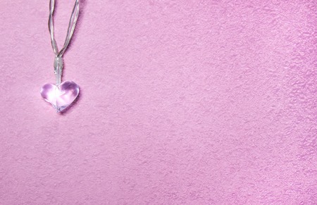 Two small glass hearts on soft pink background. Valentine's day symbol. Decorative element. Festive Valentine card.の写真素材