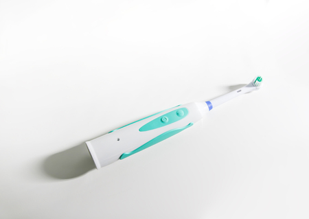 Electrical toothbrush on a soft light background.