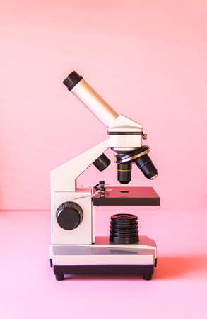Microscope on soft pink pastel background.の写真素材