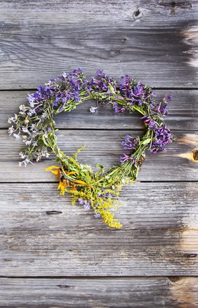 Wreath of wild flowers on the old wooden doorの写真素材