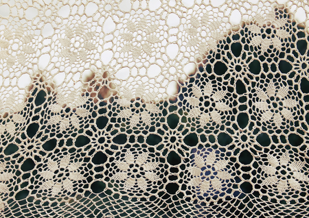 White crocheted handmade vintage tablecloth on nature  outdoors