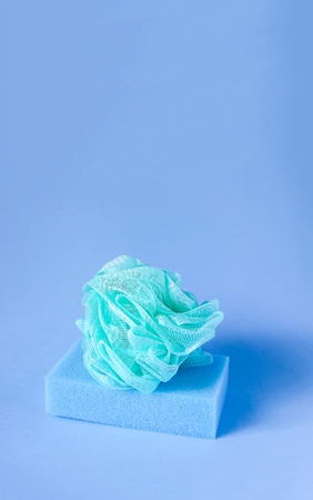 Colorful washcloths on a soft blue background. Accessories for body care and hygiene.の写真素材