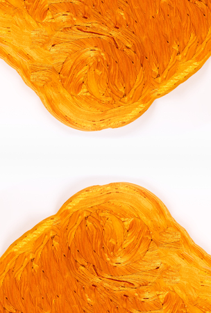 Golden plasticine soft stretchable texture on white background. Anti-stress toy for kids activities, handmade, fun.の写真素材