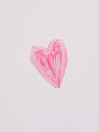Hand drawn shape of the heart. Sample of pink lip gloss on a white background.の写真素材