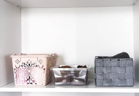 Different clothes in home wardrobe with paper notes. Small space organization. Vertical storage....