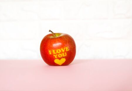 Fresh red apple with words I love you and heart.の写真素材